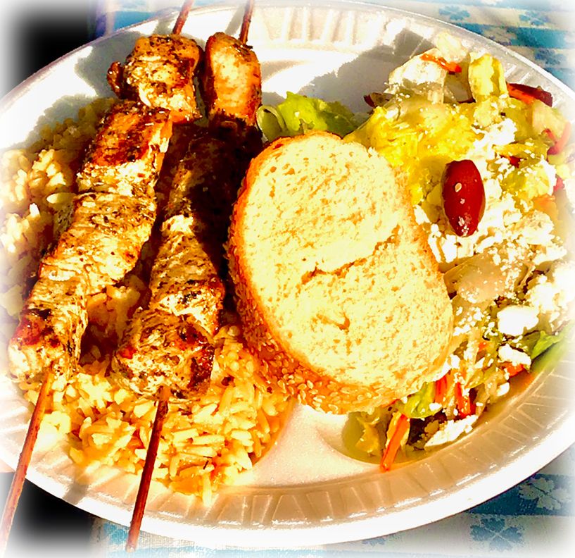 Souvlaki skewers over rice with Greek salad and bread